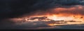 Dramatic dark sunset. Panorama of dark rain clouds in the evening Royalty Free Stock Photo