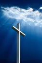 Dramatic deep blue Jesus light shining down on cross Royalty Free Stock Photo