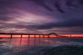 Dramatic deep purple clouds pre dawn over a bridge stretching across a body of water. Fire Island Inlet Bridge - Long Island New Y Royalty Free Stock Photo