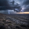 A dramatic desert landscape features a stormy sky with dark, heavy clouds Royalty Free Stock Photo