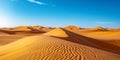 Dramatic Desert Landscape Showcasing Shifting Sand Dunes Under A Clear Blue Sky Royalty Free Stock Photo