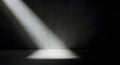Dramatic light beam cuts across a dark concrete surface, highlighting texture and creating strong contrast. Royalty Free Stock Photo