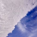 Dramatic Diagonal Sky Background: Half White Clouds, Half Deep Blue Royalty Free Stock Photo