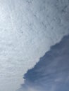 Dramatic Diagonal Sky Background: Half White Clouds, Half Deep Blue Royalty Free Stock Photo