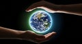 Hands protect a glowing Earth globe in dark space Royalty Free Stock Photo