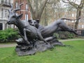 dramatic and dynamic outdoor sculpture in a London park of a lioness chasing an antelope