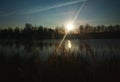 Dramatic evening light leak on the river bank