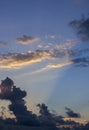 Dramatic evening sky. Clouds lit by the sun. Sun beam shining through the clouds. Royalty Free Stock Photo