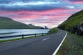 Dramatic evening view of road and Tindholmur cliffs