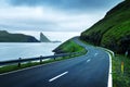 Dramatic evening view of road and Tindholmur cliffs