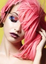 Dramatic Fashion Look young Woman in Pink Wig. Beautiful Model with bright Make-up. Carnival Accessories for Halloween