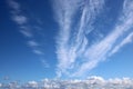 Dramatic feathery white clouds in blue sky Royalty Free Stock Photo