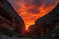 dramatic fiery sunset against the backdrop of canyon, with silhouetted figures trekking through the scene