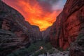 dramatic fiery sunset against the backdrop of canyon, with silhouetted figures trekking through the scene