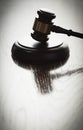 Dramatic Gavel Silhouette on Reflective Wood Royalty Free Stock Photo