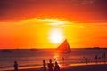 Dramatic golden sea sunset with sailboat. Summer time. Travel to Philippines. Luxury tropical vacation. Boracay paradise island. Royalty Free Stock Photo