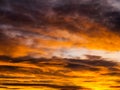 Dramatic golden sky with illuminated clouds at evening sunset time Royalty Free Stock Photo