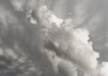 Dramatic grayscale cloudscape with towering cumulus formations casting soft shadows across the sky. Royalty Free Stock Photo