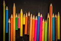 Dramatic group of pencils on black or dark background. Royalty Free Stock Photo