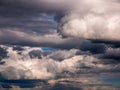 Dramatic heavy and dark rain clouds partially torn by the wind