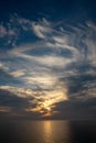 dramatic high contrast clouds in sunset over seaside beach