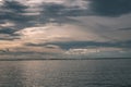 dramatic high contrast clouds in sunset over seaside beach - vintage retro look