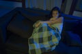 Young beautiful sad and depressed Asian Japanese woman in pain at living room sofa couch crying covering with blanket suffering Royalty Free Stock Photo