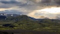 Dramatic iceland landscape with a green hill and black lava looks like a moon. Serenity of Iceland