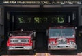 Dramatic image of a fire station with red fire trucks in garage in dominican republic.