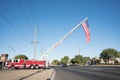 Dramatic image of a fire truck with ladder extended and a flag above a main street for September 11 memorial.