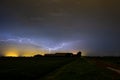 Lightning cleaving the sky above a farm