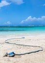 Dramatic image of a old weathered rope for anchoring boats to the caribbean shore.