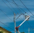 Dramatic image of power line workers in the caribbean, dominican republic.