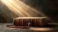 Dramatic image showing a bright light beam shining on an old bible with a rosary laying in front of it Royalty Free Stock Photo