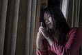 Dramatic portrait of young sad and depressed Asian Korean woman crying desperate broken heart suffering depression and anxiety in Royalty Free Stock Photo