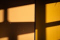 A dramatic interplay of light and shadow: sunbeams stream through a window, casting harsh geometric shadows on a Royalty Free Stock Photo