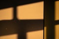 A dramatic interplay of light and shadow: sunbeams stream through a window, casting harsh geometric shadows on a Royalty Free Stock Photo