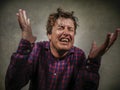 Dramatic isolated portrait of young desperate and stressed man suffering anxiety crisis and depression problem screaming Royalty Free Stock Photo