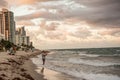 Dramatic Landscape with beautiful skies, clouds, ocean, sky rises and fisherman