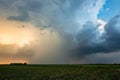Thunderstorm with precipitation shaft at sunset Royalty Free Stock Photo