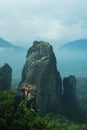 Dramatic landscape of Meteora monastery in morning fog. Royalty Free Stock Photo