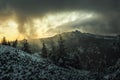 Dramatic landscape in the mountains in Poland with beautiful scary sky and winter forest