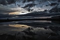 Dramatic landscape with reflections at sunset over the salt-mines in Pomorie with a trace of airplane.