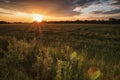 Dramatic landscape view with sun rays shining through a dark cloudy sky Royalty Free Stock Photo