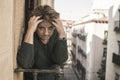 Dramatic lifestyle portrait of mature woman on her 70s crying depressed and sad at home balcony feeling desperate suffering Royalty Free Stock Photo