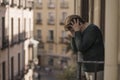 Dramatic lifestyle portrait of mature woman on her 70s crying depressed and sad at home balcony feeling desperate suffering Royalty Free Stock Photo