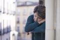 Dramatic lifestyle portrait of mature woman on her 70s crying depressed and sad at home balcony feeling desperate suffering Royalty Free Stock Photo