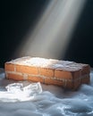 Dramatic light illuminates a brick structure covered in snow and ice, creating a cold, stark scene. Royalty Free Stock Photo