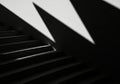 Dramatic light and shadow play creates abstract geometric patterns on stairs Royalty Free Stock Photo