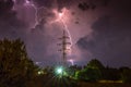 Dramatic lightning over high voltage pylon